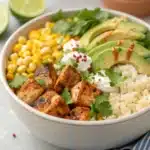 Finished street corn chicken rice bowl with grilled chicken cubes, avocado, corn, and cheese
