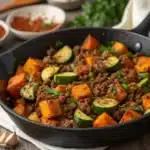 Ground beef skillet with sweet potatoes, zucchini, and fresh herbs