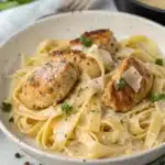 Garlic butter chicken bites over creamy parmesan fettuccine pasta