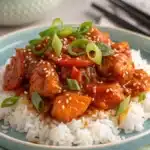 Sweet chili chicken served on jasmine rice with sesame seeds