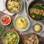 Assorted vegetarian pasta dishes with colorful sauces and fresh vegetables