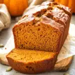Close-up of classic homemade pumpkin bread sliced on a rustic board