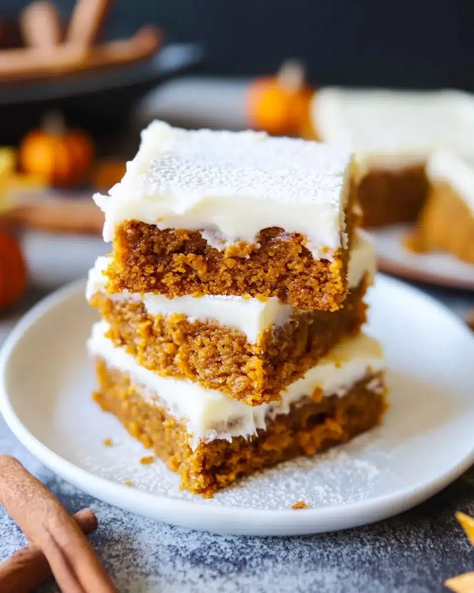 Pumpkin squares with cream cheese frosting and cinnamon dusting