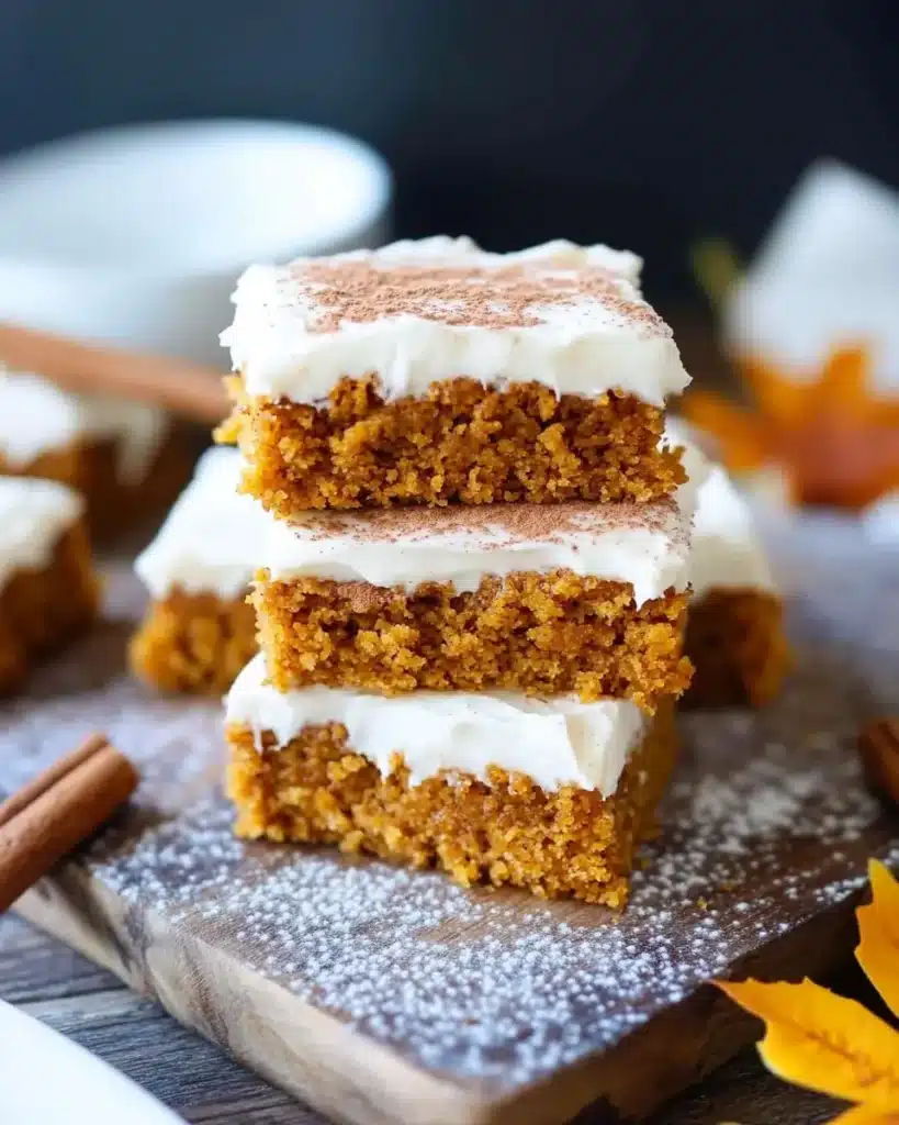 Gluten-free pumpkin squares stacked with cream cheese frosting