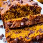 Moist chocolate chip pumpkin bread loaf sliced with melty chocolate chips.