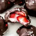 Frozen strawberry yogurt bites dipped in chocolate with sea salt