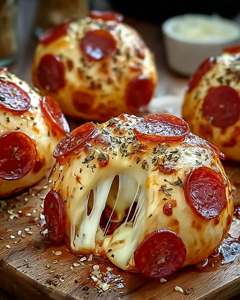 Cheesy pepperoni pizza bombs oozing melted mozzarella on wooden board