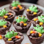 Halloween brownie cauldrons with candy frogs, candy corn, and chocolate pieces