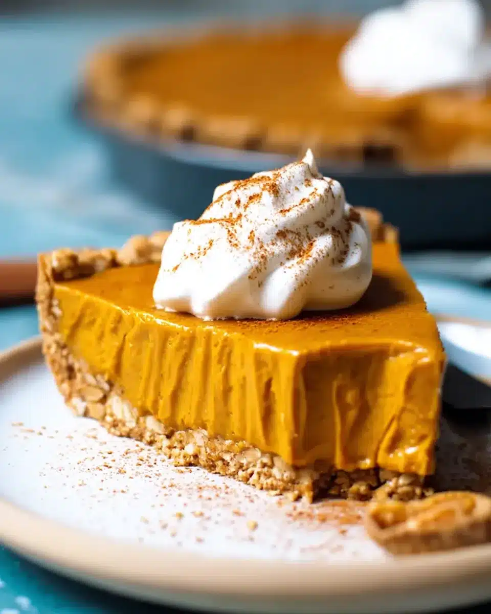 Vegan pumpkin pie with oat-topped crust and slice cut out