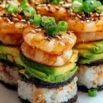 Spicy shrimp sushi stack with avocado, rice, nori, sesame, and scallions