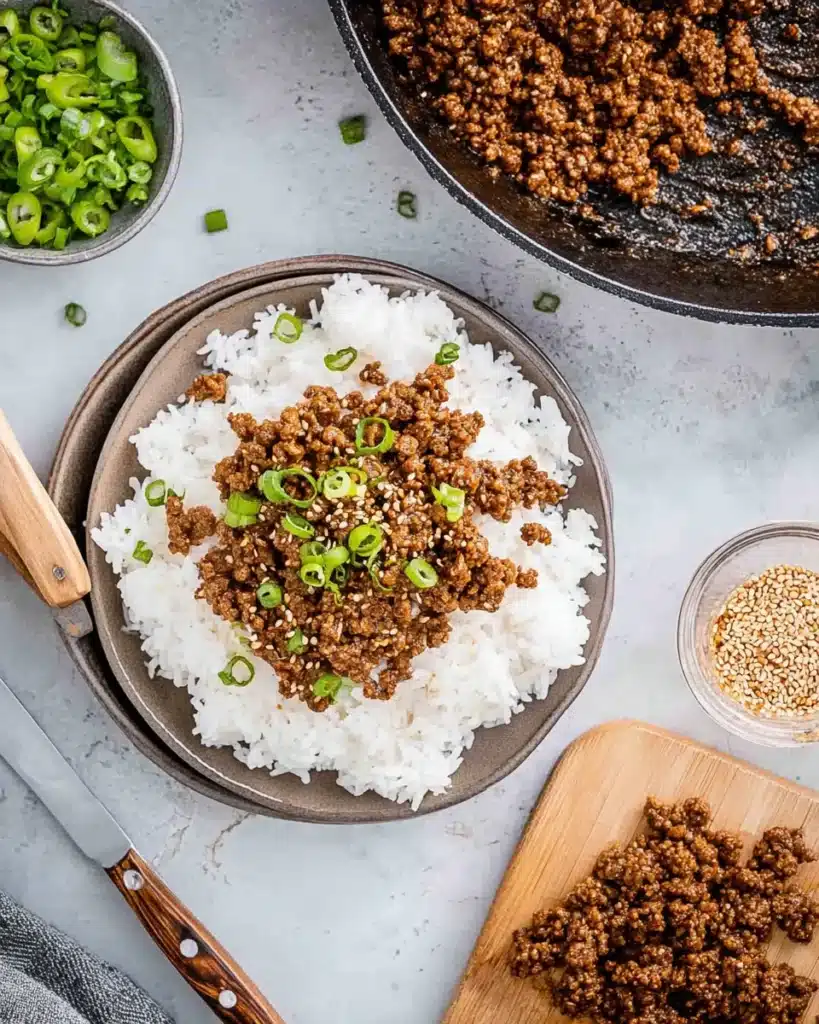 Ground beef and rice topped with green onions and sesame seeds.