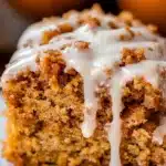 Moist pumpkin coffee cake slice with cinnamon streusel and glaze