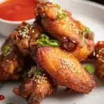 Crispy Chinese chicken wings with sesame seeds and chili sauce