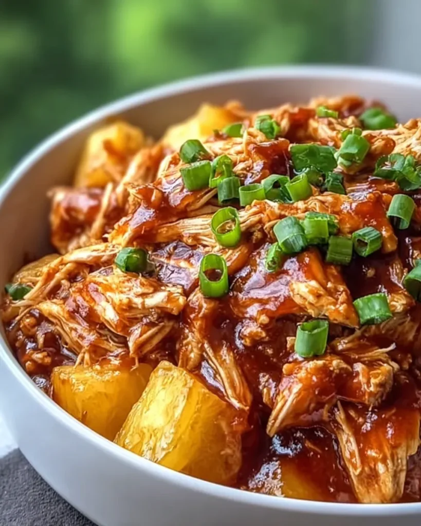 Tender BBQ chicken with pineapple chunks and green onions in sauce