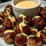 Stacked Korean BBQ meatballs drizzled with gochujang mayo and scallions