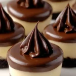 Close-up of mini chocolate cheesecake with cookie crust and ganache swirl