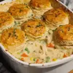 Golden biscuit-topped homemade chicken pot pie casserole with creamy filling