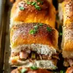 Mini Cuban slider with pulled pork, ham, pickles, and Swiss on a golden Hawaiian roll