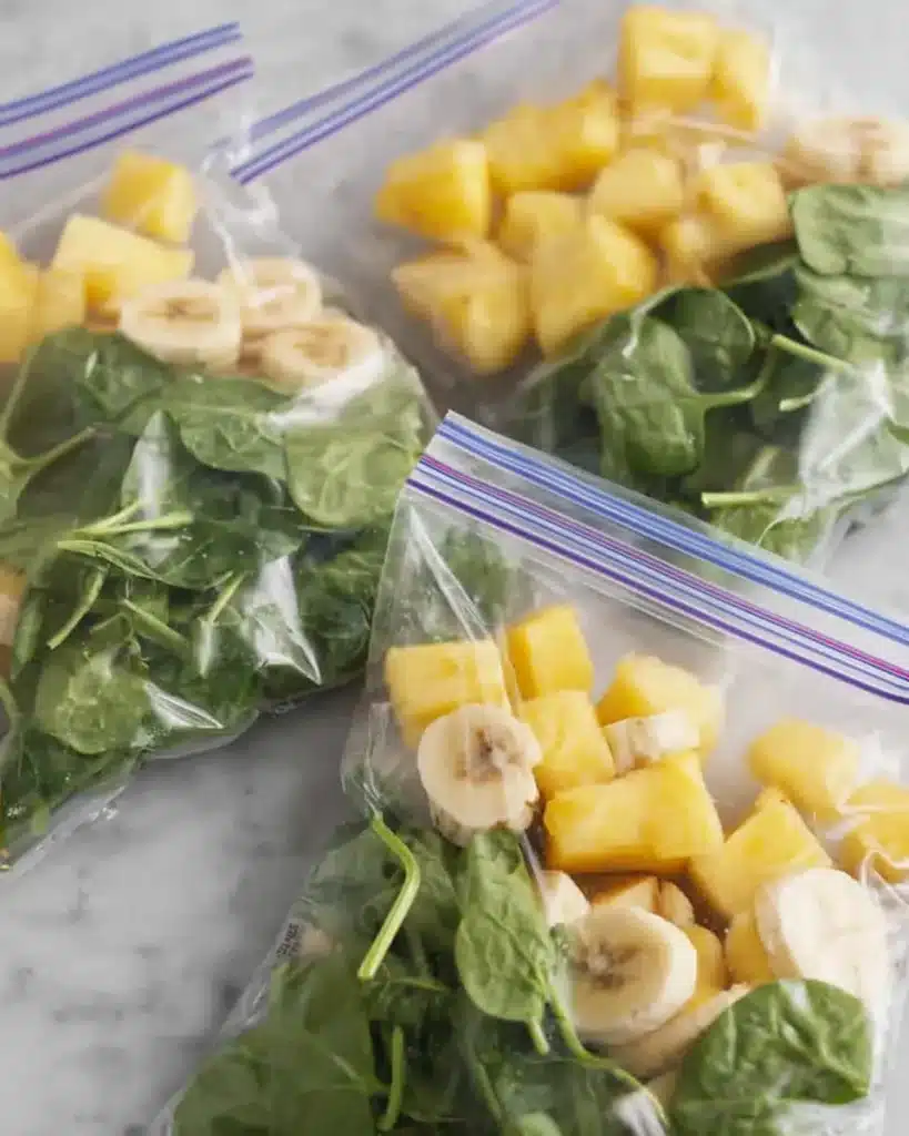 Freezer bags with spinach, banana, and pineapple for green smoothies