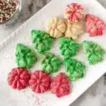 Festive Christmas spritz cookies shaped like trees and flowers